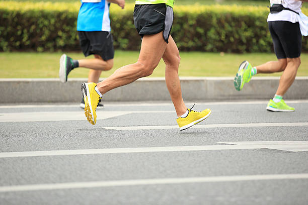istock marathon runner athletes  running on city road 529837771
