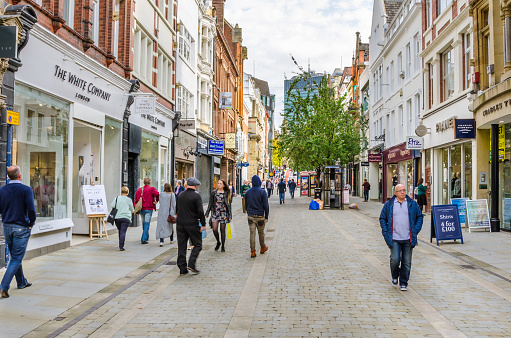 Manchester, Uk - October 3, 2014: Shoppers and tourists strolling around King Street on a warm autumn day. King Street is lined with many historic buildings and smart shops. It is considered, along with Bridge Street, Manchester's most upmarket shopping area .