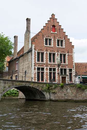Bruges, Belgium - June 14, 2013: Typical brickhouse in Bruges view from a boat.
