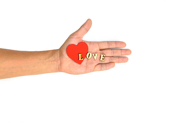 istock Hand with heart and letter LOVE 529840323
