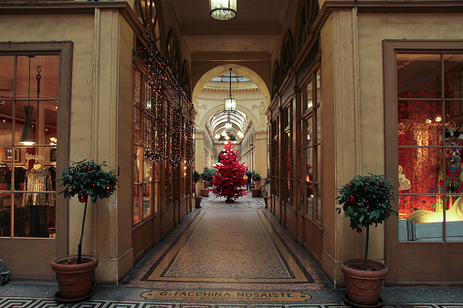 Red Christmas tree in corridor with boutiques