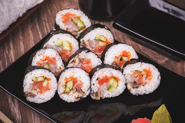 istock assorti fish sushi roll on black plate 529873863