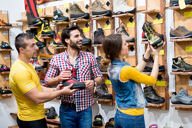 istock People in the shoe store choosing boots 529874699