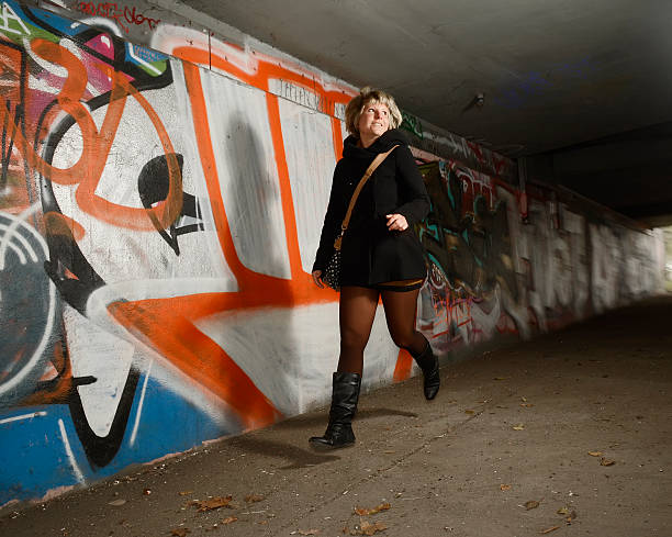 istock Frightened young woman alone in tunnel, running away 529875579