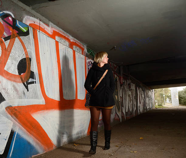 istock Frightened young woman alone in tunnel 529875597