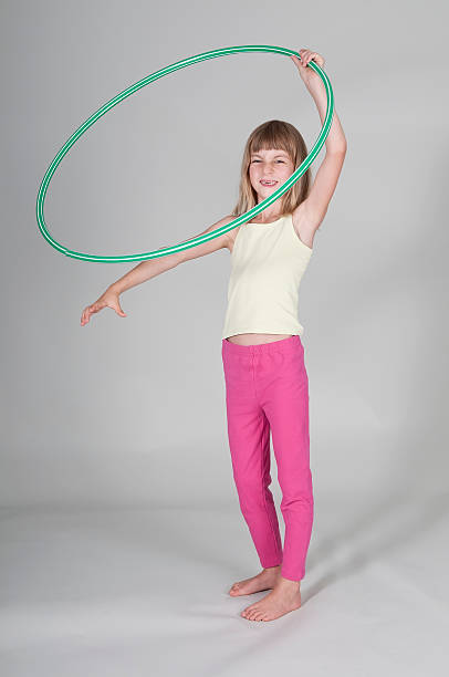 istock Blonde girl exercising hoola hoop 529875995