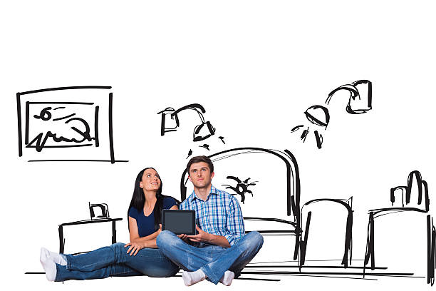 istock Composite image of young couple sitting on floor with tablet 529899095