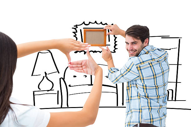 istock Composite image of happy young couple putting up picture frame 529899129