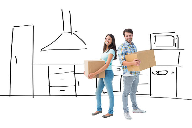 istock Composite image of happy young couple with moving boxes 529899211