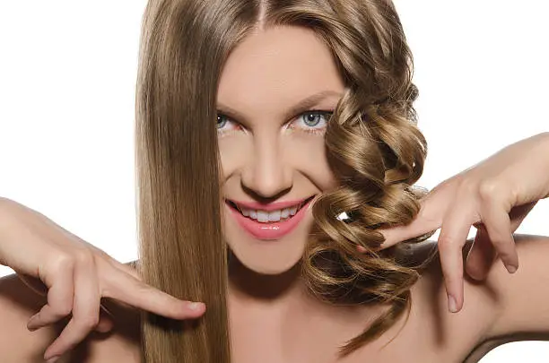 Photo of Woman with haircut keeps hair in hands