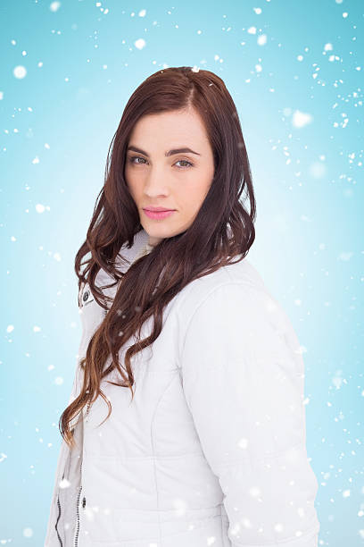 istock beauty brown hair in white coat posing 529900443