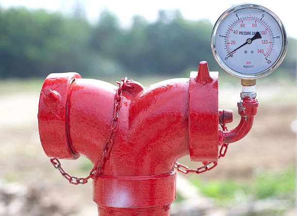 istock red metallic fire hydrant with pressure gauge or Fire Department 529900911