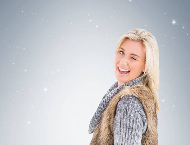istock Blonde in winter clothes smiling 529902217