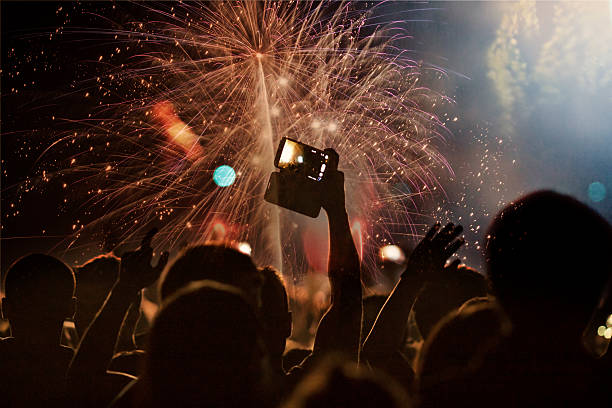istock New Year concept - cheering crowd and fireworks 529903479