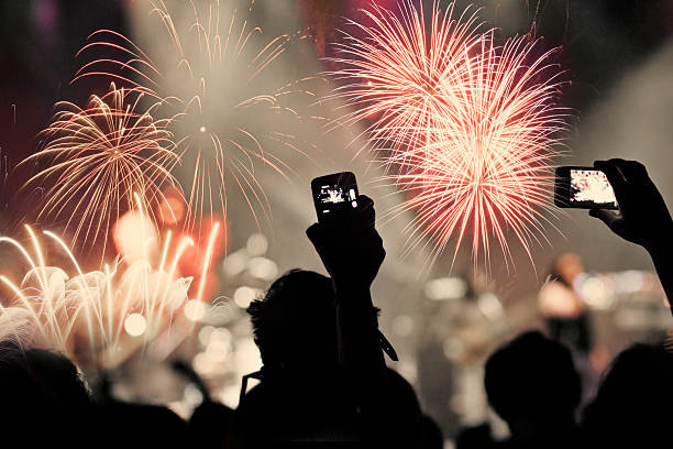 istock New Year concept - cheering crowd and fireworks 529903481
