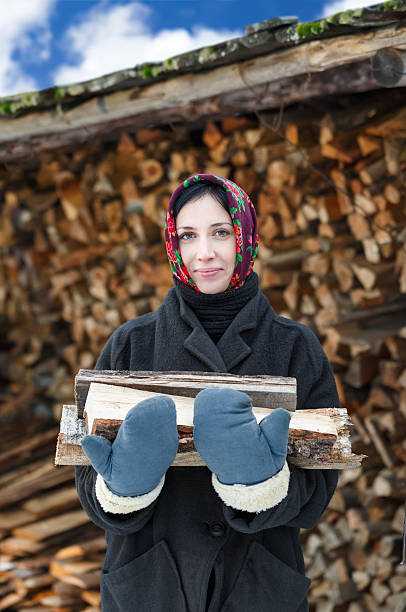 istock woman in ethnic costume with firewood 529904683