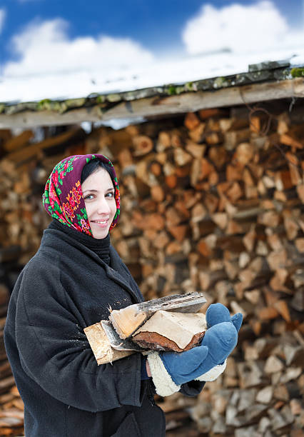 istock woman in ethnic costume with firewood 529904687