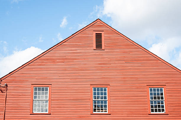 istock Three windows in end wall of red building. 529906035