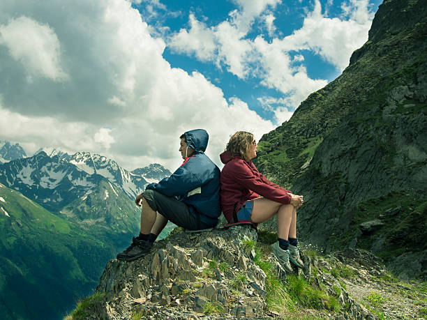 istock Toned image men and women sitting on the rock 529915133