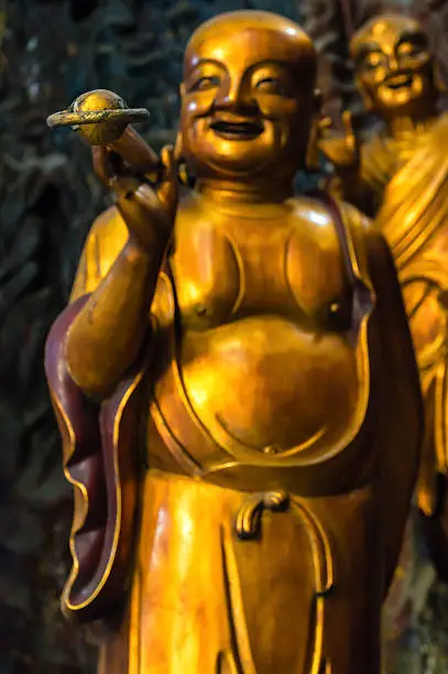 Detail of A Happy Monk on Guanyin, a manifestation of the Bodhisattva AvalokiteÅvara, with relief screen, at the back of the Grand Hall of the Great Sage.  Lingyin Temple, Hangzhou, Shandong Province, China