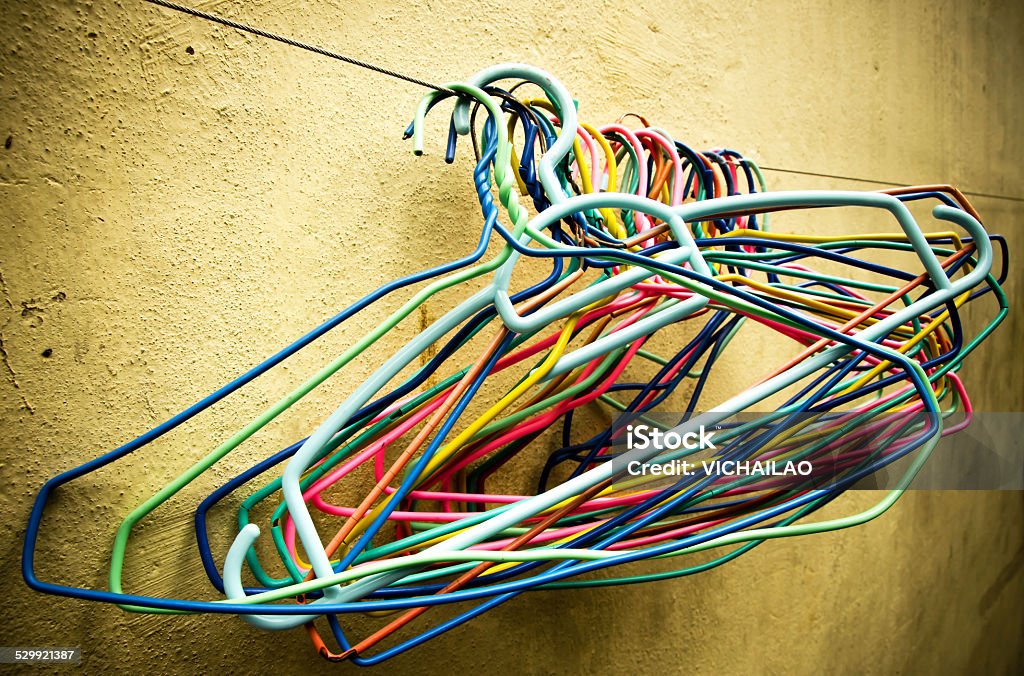 Close up of old clothes hangers in the sunlight Close up of old clothes hangers. outdoor (colorful, hangers, old) Closet Stock Photo