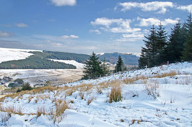 Snow capped hills in the Brecon Beacons National Park, Wales.  Footprints can seen in the snow indicating the passage of hill walkers.
