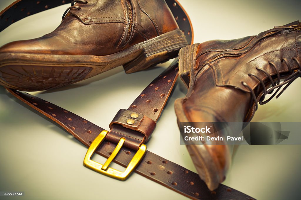 Fashionable shoes handmade leather belt with a buckle Fashionable shoes handmade leather belt with a buckle. grunge style. cowboy style Adult Stock Photo