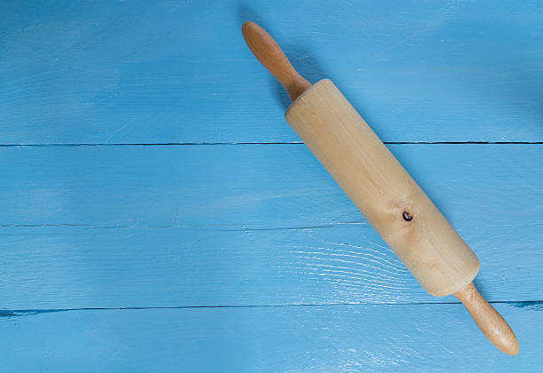 istock Rolling pin on blue wood as a background 529929385