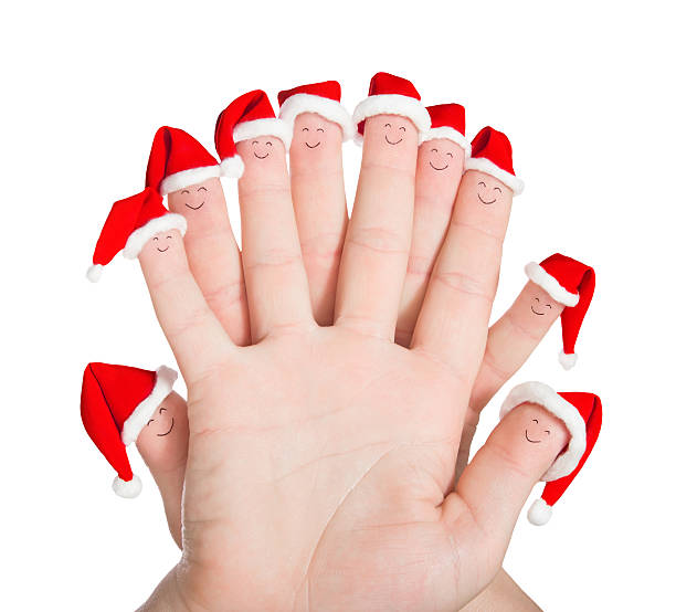 istock Fingers faces in Santa hats isolated on white background. Concep 529929555