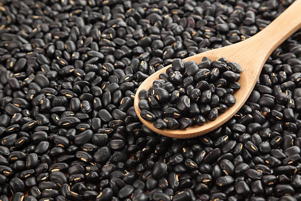 istock Black beans with wooden spoon 529929633