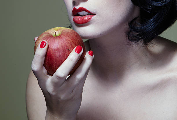 Biting an apple stock photo