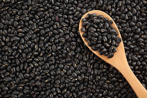 istock Black beans with wooden spoon 529930971