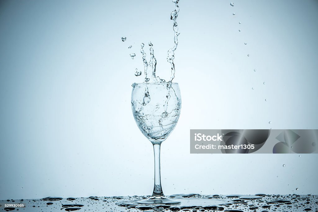 glass being filled with water A glass being filled with water on white background Glass - Material Stock Photo