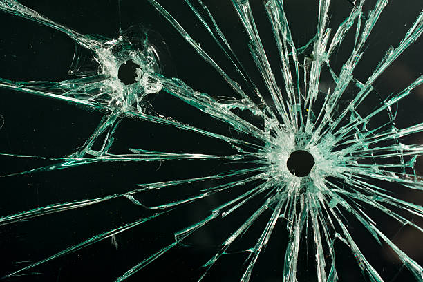 istock Gun and Bullet Hole Glass 529933171