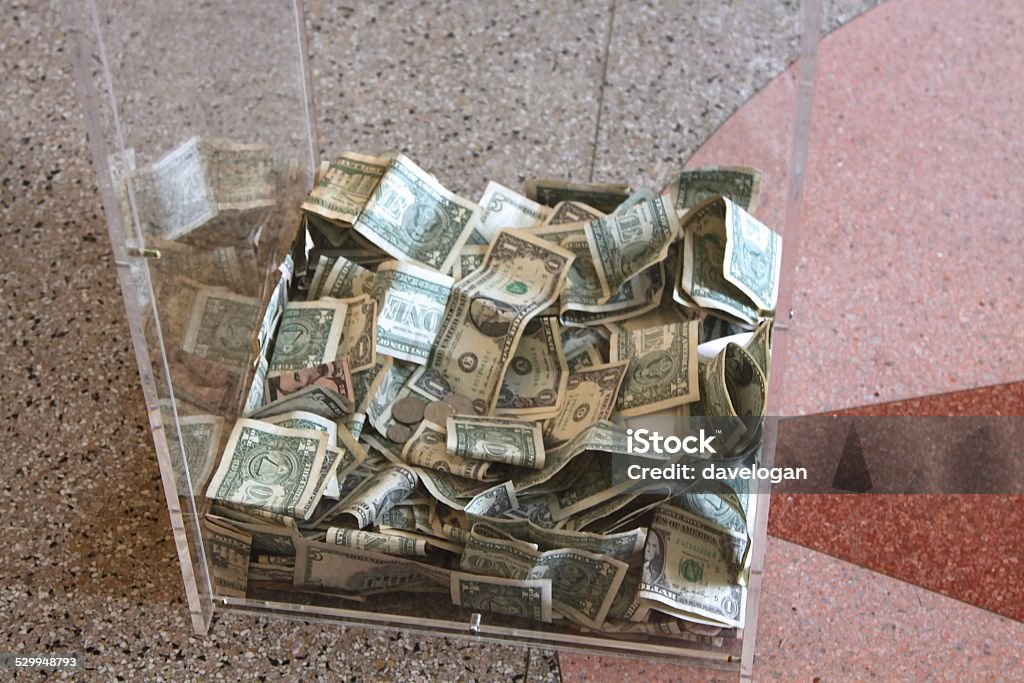 Money In Donation Box Money at the bottom of a donation  box Box - Container Stock Photo