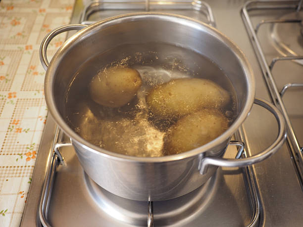 istock Saucepot with potatoes on cooker 529950583