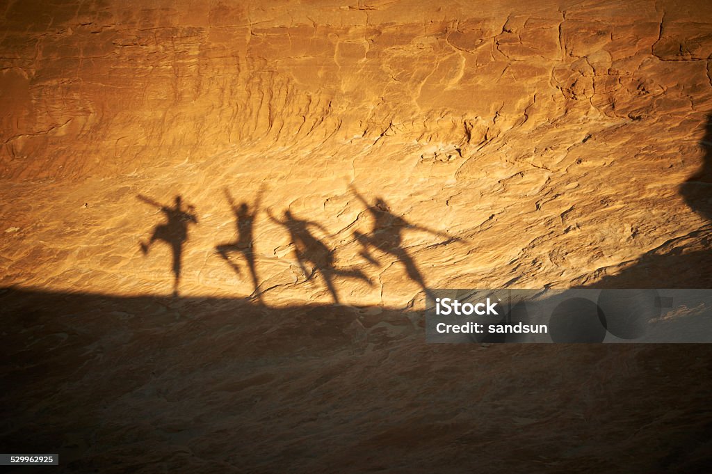 dancing shadows shadows of people on a rock in the desert Dancing Stock Photo