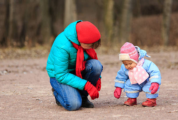 istock mother and little daugther playing in winter 529964953