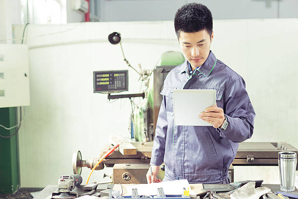 istock mechanic  worker using tablet in workshop of factory 529966563