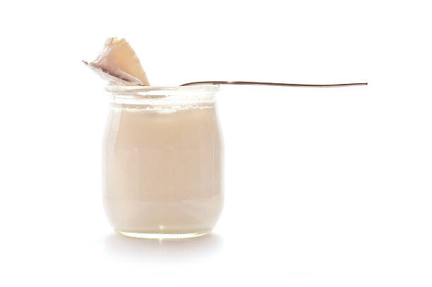 istock Yoghurt and a spoon isolated on white background 529968295