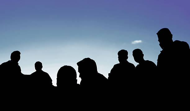 istock People silhouette over the blue sky 529976591