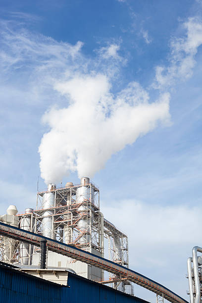 istock Industrial smoke from chimney on blue sky 529978334