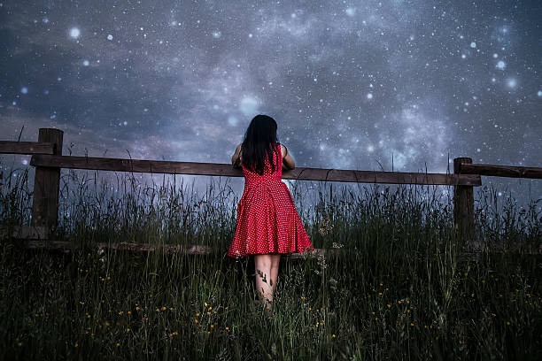 Woman in red dress watching the stars
