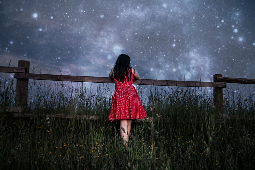 Woman in red dress watching the stars