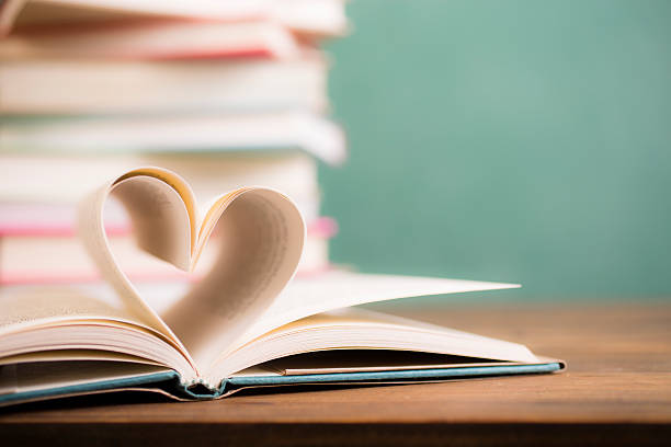 istock Love Reading!  Heart shape in open book pages. Education, school. 529979692