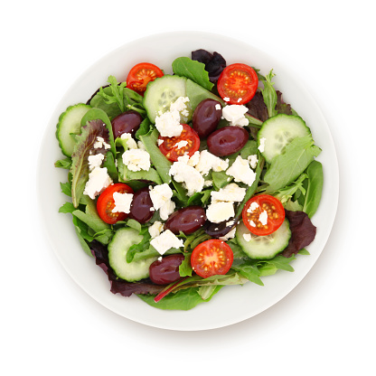 Greek salad with cucumber, cherry tomatos, olives and feta cheese isolated on white (excluding the shadow)