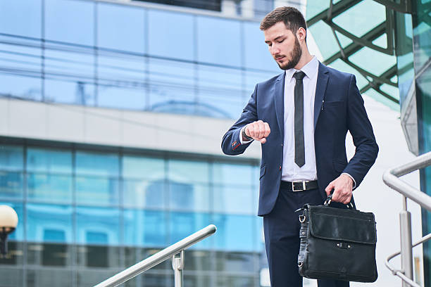 istock Businessman stands look at the clock on 529981380