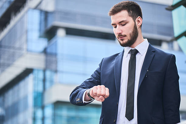 istock Businessman stands look at the clock on 529981502