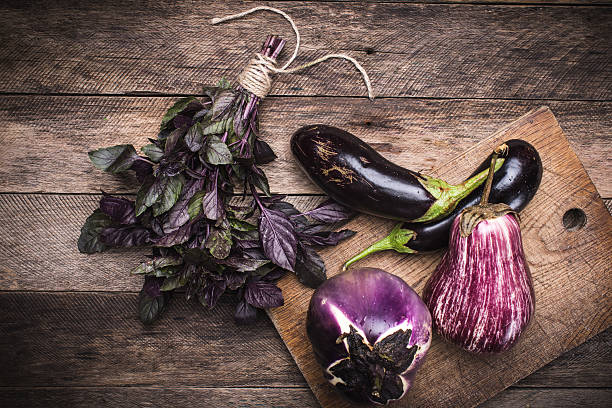 istock Rustic style Aubergines and basil on chopping board 529981871