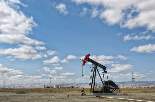 istock Oil Pumpjack with Clouds in Background 529982634